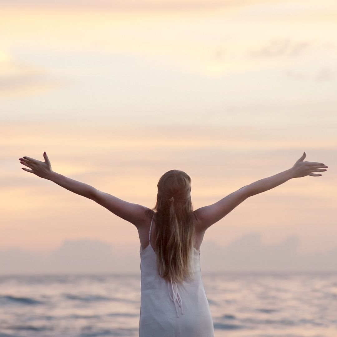 Happy Woman at the Beach with Spread Arms-Skilled Regional visa (subclass 887) -widen migration experts