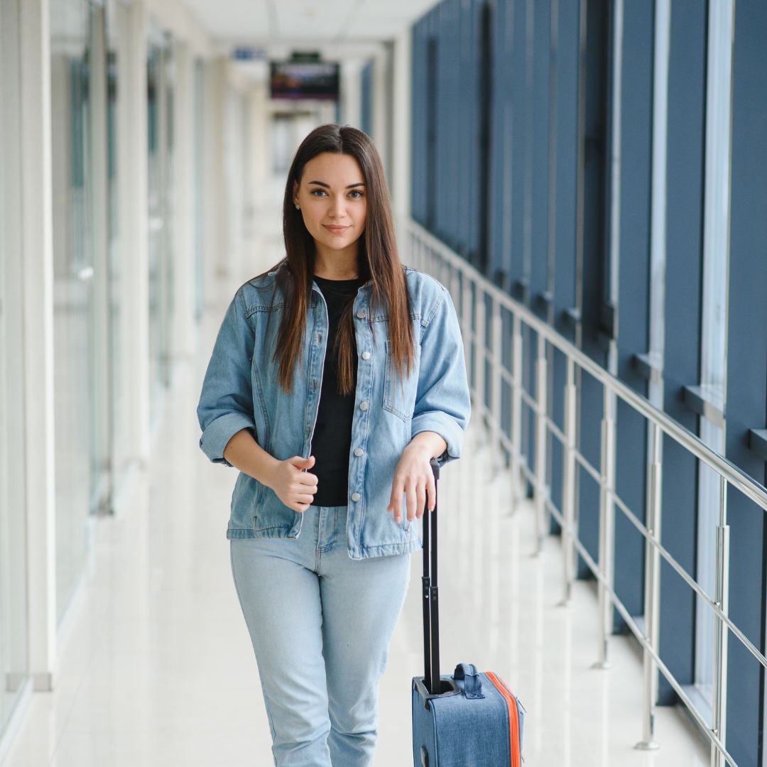 pretty woman waiting for her flight at airport - widen migration experts